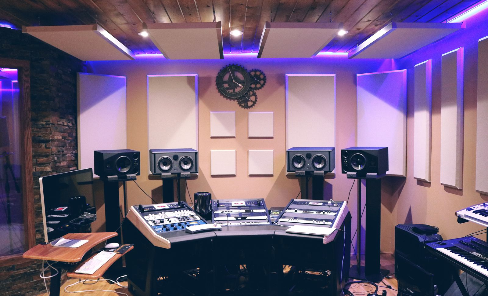 A recording studio with mixing equipment, monitors and keyboards